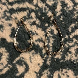 Golden earrings with accent jewels intertwined